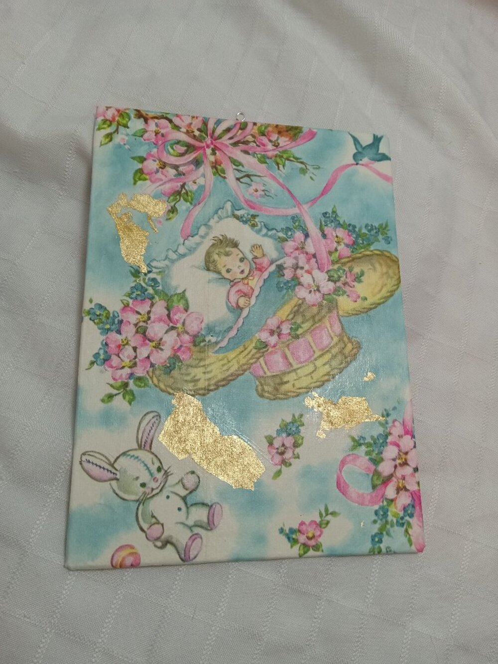 A delicate, handmade canvas made from thin vintage wrapping paper